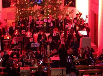 Orchester vor dem Weihnachtsbaum, rotes Licht